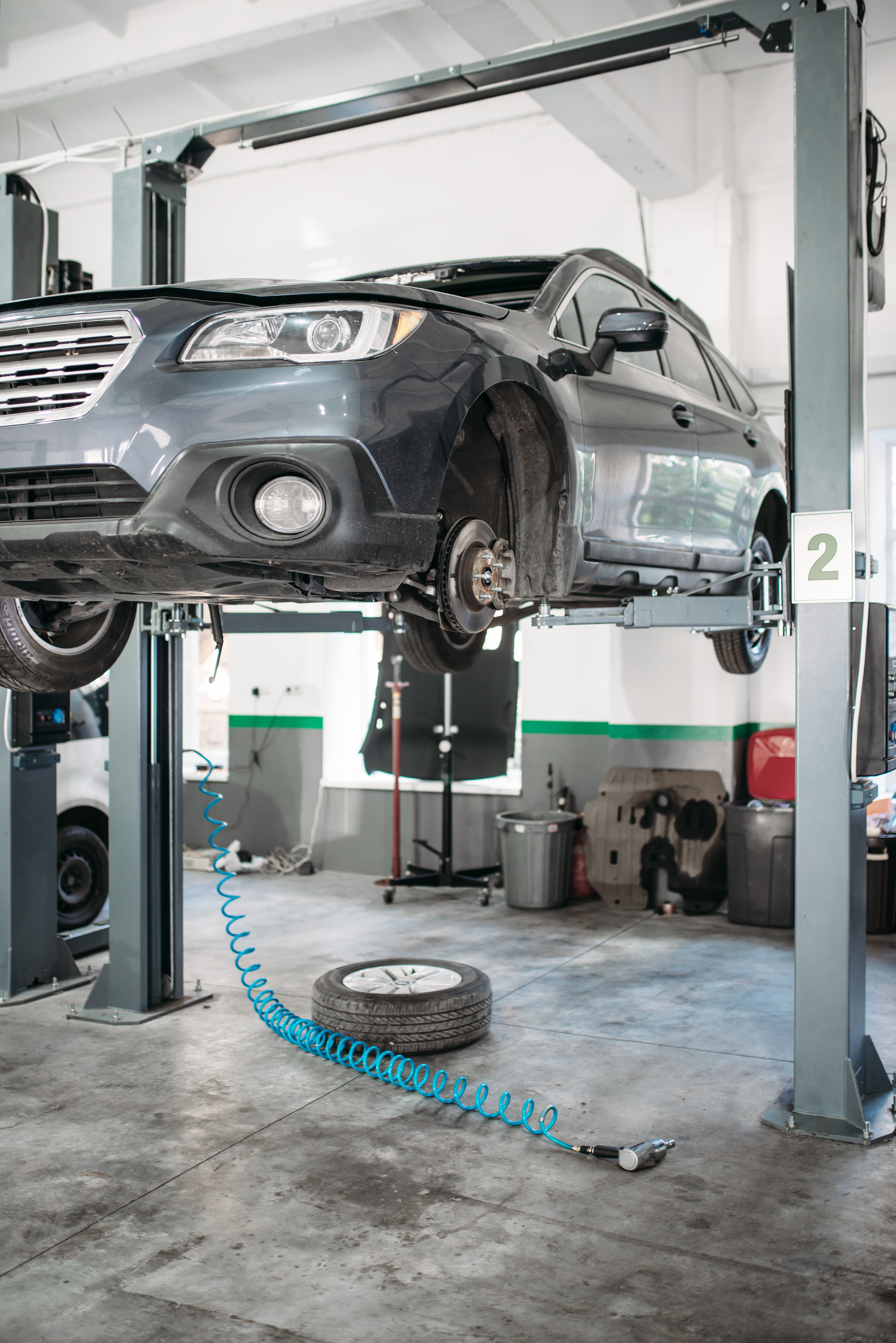 Vehicle on lift during brake and suspension service
